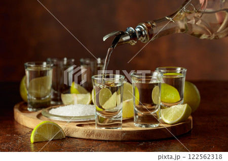 Gold tequila with salt and lime slices. Gold tequila with salt and lime slices. 122562318