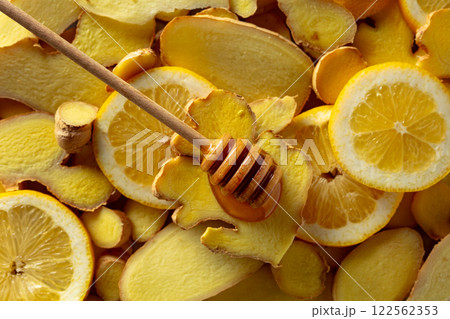 Honey with fresh ginger and lemon slices. Honey with fresh ginger and lemon slices. 122562353