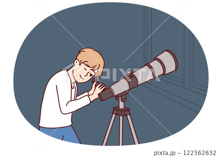 Teenager boy with telescope watches stars and is fond astrology while standing near window 122562632