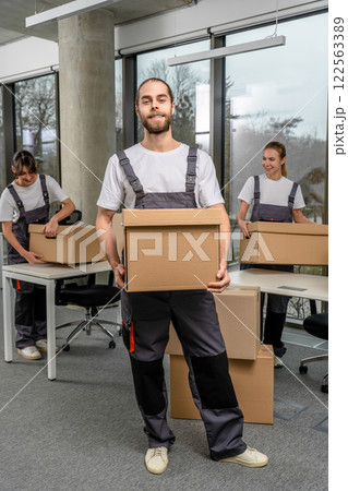 Bearded caucasain packaging center worker with a cardboard box in hands Bearded caucasain packaging center worker with a cardboard box in hands 122563389