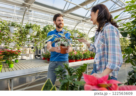 Gardener man advising male client during buying flowers in garden center 122563609