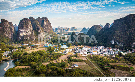 Aerial view of a scenic valley among majestic mountains and a river 122563978