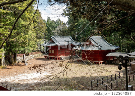 Two traditional buildings in the middle of a lush green forest in Nikko Japan 122564087