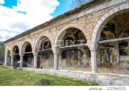 A stone building with arches and beautiful paintings on its side A stone building with arches and beautiful paintings on its side 122564225