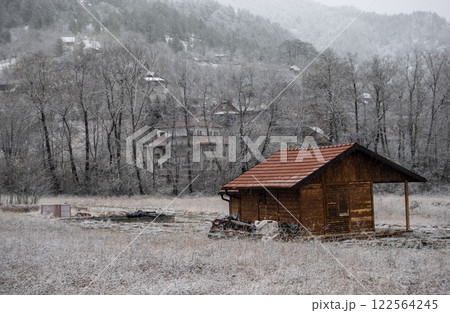 A quaint wooden hut in snowy field, surrounded by whiteness. Mokra Gora. Serbia 122564245