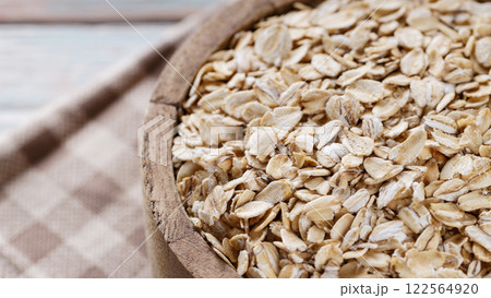 Oat Flakes in Wooden Bowl Close-Up Oat Flakes in Wooden Bowl Close-Up 122564920
