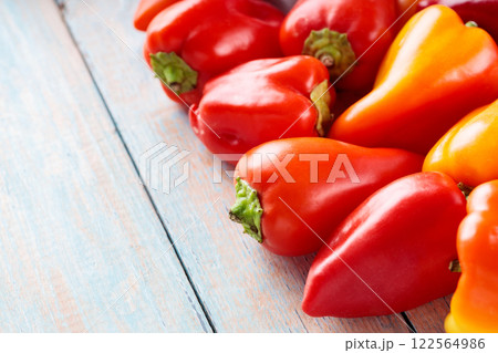 Red and Orange Bell Peppers on Wooden Background for Healthy Farm-Fresh Nutrition, Top View, Copy Space 122564986
