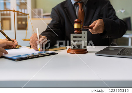 Justice and law concept. Real Estate Law in a courtroom the gavel, working with digital tablet computer. Justice and law concept. Real Estate Law in a courtroom the gavel, working with digital tablet computer. 122565316