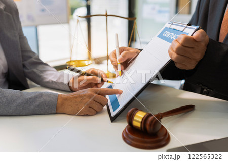 Legal counsel presents to the client a signed contract with legal law. justice and lawyer concept in office. 122565322