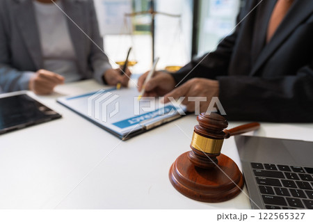 Business people and lawyers discussing contract papers sitting in the table at office in the morning. concepts of law, advice, legal services. 122565327