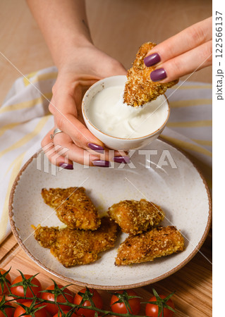 Hand Dipping Crispy Nugget into Creamy Sauce Hand Dipping Crispy Nugget into Creamy Sauce 122566137