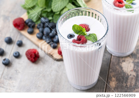 Fresh raspberry and blueberry smoothie on wooden table 122566909