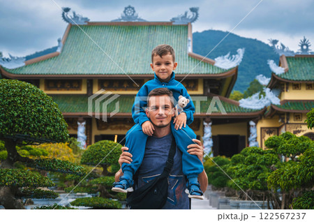 family of tourists dad and son at Buddhist temple at Linh Ung Pagoda in Da Nang in Vietnam. Travel and tourism in Asia 122567237