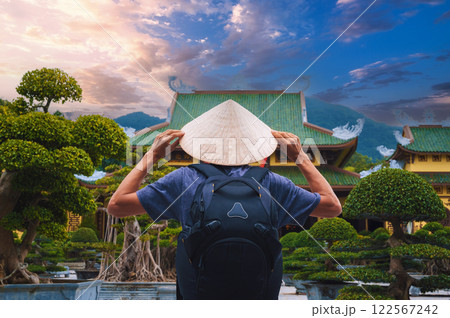 back of male tourist traveler at Buddhist temple at Linh Ung Pagoda in Da Nang in Vietnam. Concept of travel and tourism in Asia 122567242