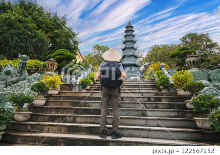 back of a male tourist traveler at Linh Ung Pagoda in Da Nang in Vietnam. Concept of travel and tourism in Asia back of a male tourist traveler at Linh Ung Pagoda in Da Nang in Vietnam. Concept of travel and tourism in Asia 122567252