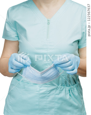 Hands of a female doctor in latex gloves with a medical mask. Hands of a female doctor in latex gloves with a medical mask. 122567637