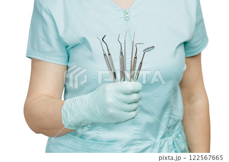 Set of metal dental instruments for teeth dental care in hands. Set of metal dental instruments for teeth dental care in hands. 122567665