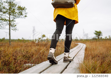 Hiking shoes of woman walking on wooden bridge. Copy Space on outdoor background. Active lifestyle 122569340