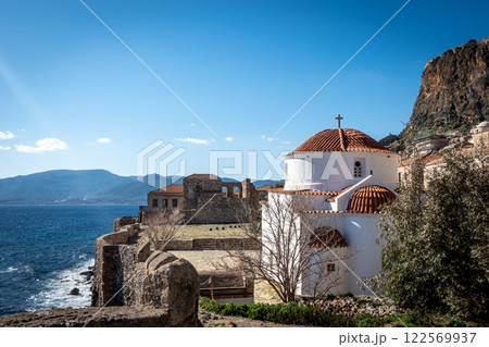 Beautiful Orthodox church in Monemvasia with stone wall and wavy sea. Greece 122569937