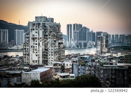 Macau contrasts. Biggest old building in the old town with new skyscrapers 122569942
