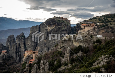 There is a collection of buildings that is located on a rocky mountain top 122570112