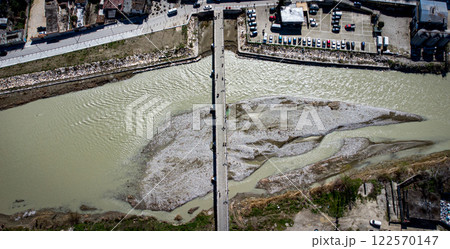 90 degree take over Berat oldest bridge with river and people crossing. Albania 90 degree take over Berat oldest bridge with river and people crossing. Albania 122570147