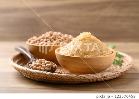 Miso paste in wooden bowl, Japanese seasoning made from fermenting soybeans with salt Miso paste in wooden bowl, Japanese seasoning made from fermenting soybeans with salt 122570458