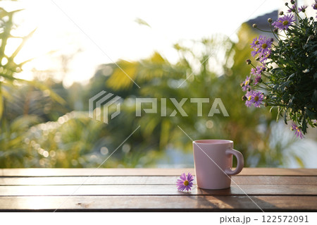A Pink coffee cup with pink Daisy flower cozy garden view 122572091