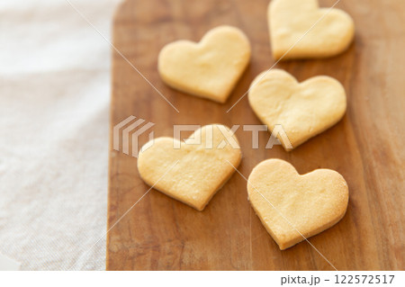 木製ボードの上に並んだハート型の手作りクッキー 木製ボードの上に並んだハート型の手作りクッキー 122572517