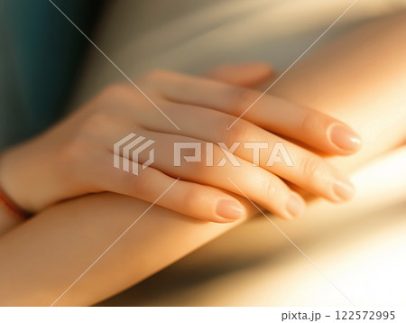 Close-up of two hands gently resting on each other Close-up of two hands gently resting on each other 122572995
