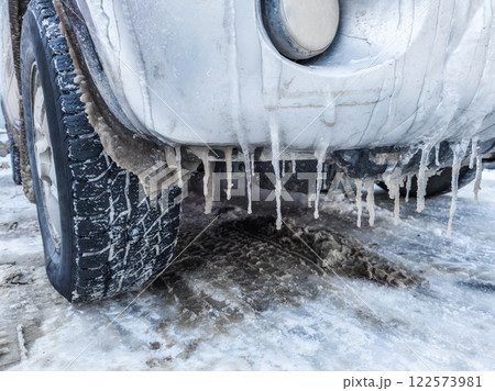 Icicles Are Forming under a Car bumper in Harsh Winter Conditions and Cold Environments 122573981