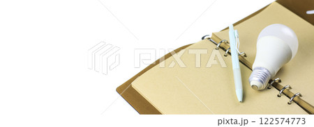 White light bulb on an open notebook, symbolizing creativity, innovation, inspiration and new ideas. 122574773