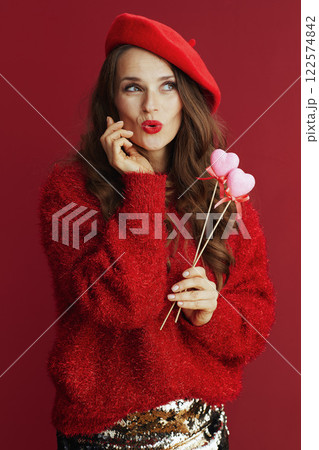 pensive elegant woman in red sweater and beret 122574842