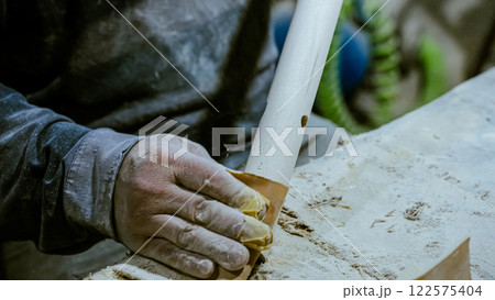 carpenter using nail gun or brad nailer tool on wood box in a workshop ,furniture restoration woodworking concept. selective focus carpenter using nail gun or brad nailer tool on wood box in a workshop ,furniture restoration woodworking concept. selective focus 122575404