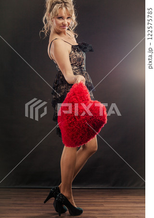 Mature woman holds big red heart Mature woman holds big red heart 122575785