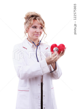 Doctor with stethoscope examining red heart. 122575803