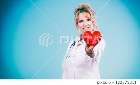 Middle aged blonde doctor enjoy her work. 122575811