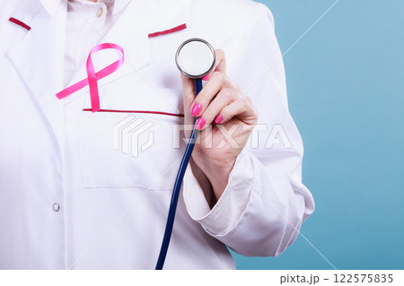 Pink ribbon with stethoscope on medical uniform. 122575835