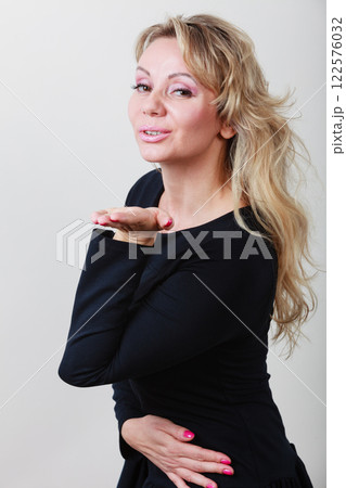 Elegant woman blowing kiss. Elegant woman blowing kiss. 122576032