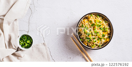 A bowl of instant noodles and vegetables on the table top view web banner A bowl of instant noodles and vegetables on the table top view web banner 122576192