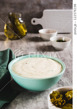 Traditional ranch dressing made with cottage cheese and pickles in a bowl vertical view Traditional ranch dressing made with cottage cheese and pickles in a bowl vertical view 122576196