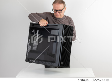 Man holding a heavy PC case, weight 15,8 kg, empty big tower, chassis. 122576576