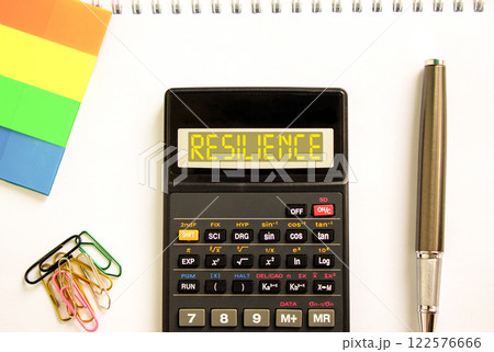 Resilience symbol. Concept word Resilience on beautiful black calculator. Beautiful white paper background. Beautiful black pen. Colored paper. Business resilience concept. Copy space. Resilience symbol. Concept word Resilience on beautiful black calculator. Beautiful white paper background. Beautiful black pen. Colored paper. Business resilience concept. Copy space. 122576666