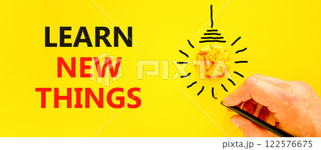 Learn new things symbol. Concept words Learn new things on beautiful yellow paper. Beautiful yellow background. Businessman hand. Light bulb. Business motivational learn new things concept. Copy space 122576675
