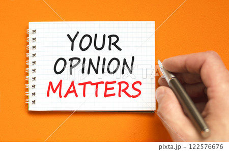 Your opinion matters symbol. Concept words Your opinion matters on beautiful white note. Beautiful orange background. Black pen. Businessman hand. Business your opinion matters concept. Copy space. 122576676