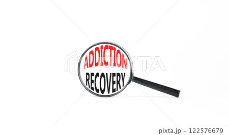 Addiction recovery symbol. Concept words Addiction recovery on beautiful black magnifying glass. Beautiful white table white background. Psychology addiction recovery concept. Copy space. Addiction recovery symbol. Concept words Addiction recovery on beautiful black magnifying glass. Beautiful white table white background. Psychology addiction recovery concept. Copy space. 122576679