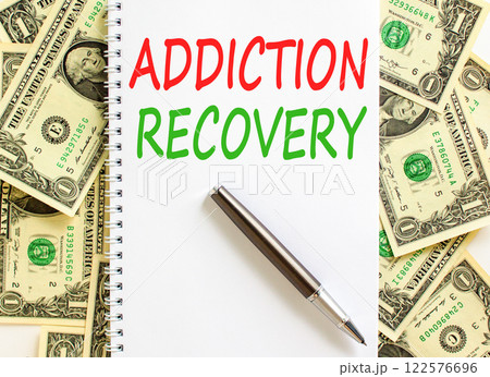 Addiction recovery symbol. Concept words Addiction recovery on beautiful white note. Beautiful background from dollar bills. Black pen. Psychology addiction recovery concept. Copy space. 122576696