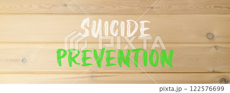 Suicide prevention symbol. Concept words Suicide prevention on beautiful wooden wall. Beautiful wooden wall background. Psychological and suicide prevention concept. Copy space. 122576699