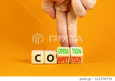 Competition or cooperation symbol. Concept word Competition or Cooperation on wooden cubes. Businessman hand. Beautiful orange background. Business Competition or cooperation concept. Copy space. Competition or cooperation symbol. Concept word Competition or Cooperation on wooden cubes. Businessman hand. Beautiful orange background. Business Competition or cooperation concept. Copy space. 122576716