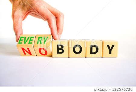 Everybody vs nobody symbol. Concept words Everybody and Nobody on wooden cubes. Beautiful white table white background. Businessman hand. Business and everybody vs nobody concept. Copy space. 122576720